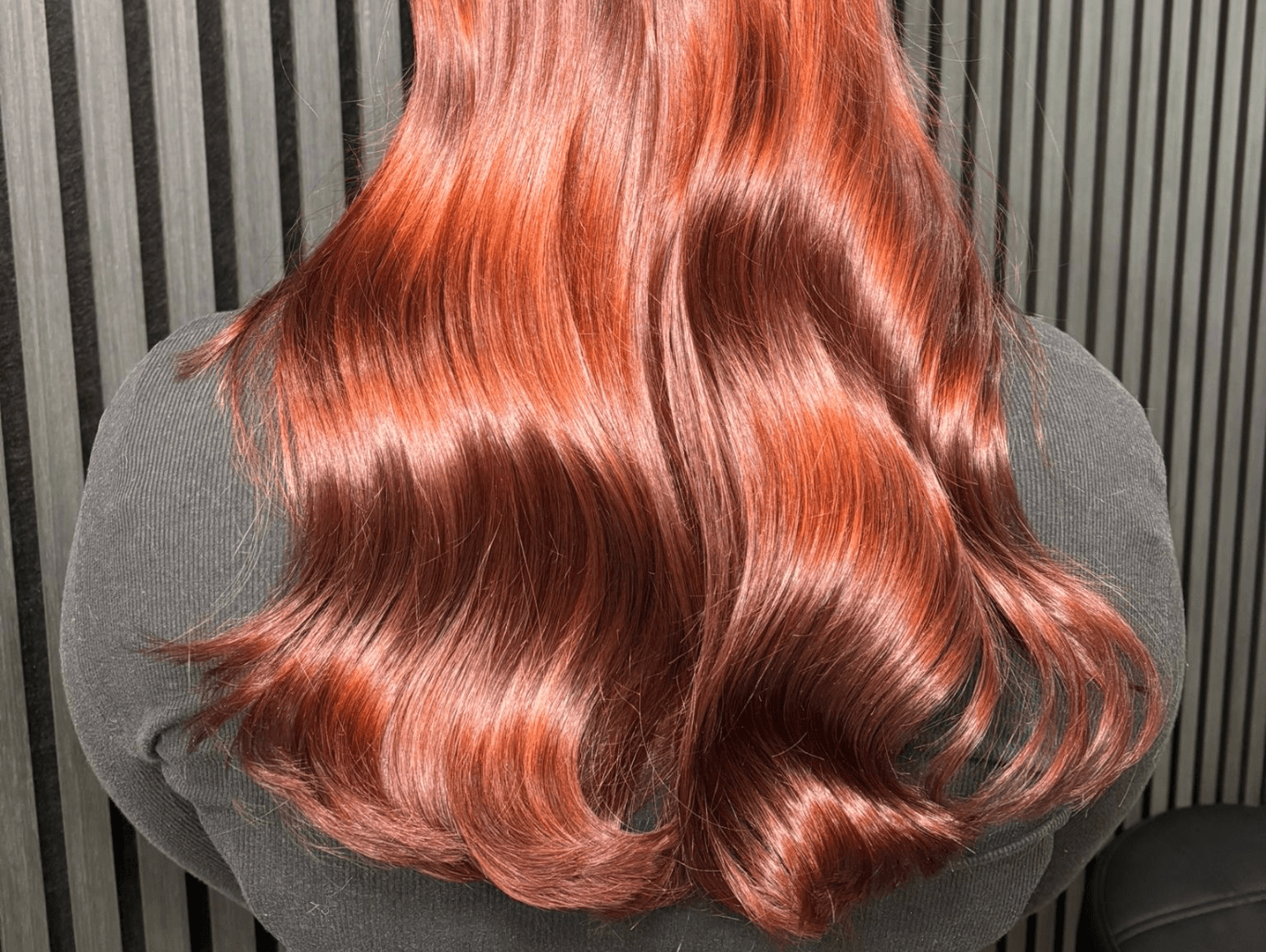 Rich copper red hair colour with glossy waves by colour specialist in Corringham
