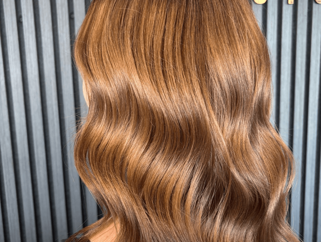 Glossy brunette hair with warm copper tones styled at Nicolas Ablitt Hair Studio in Corringham, Essex