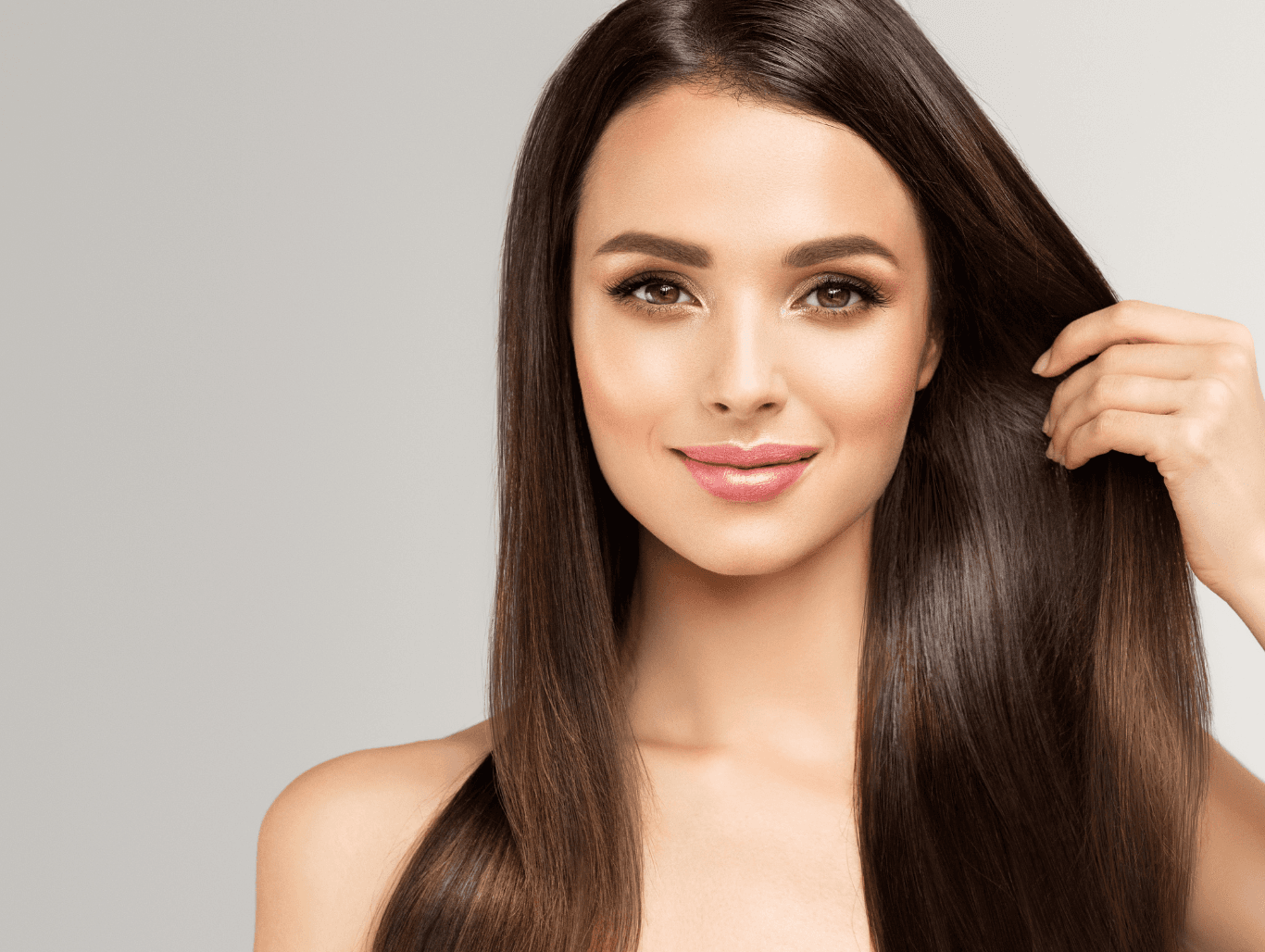 Woman with sleek, straight, glossy brown hair after professional smoothing treatment at a Corringham hair salon.